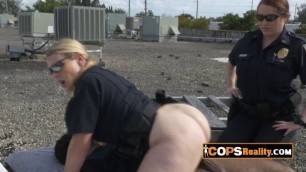 Black suspect is getting arrested and fucked on the rooftop by two big titty cops.
