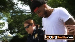 Black suspect is under interrogation with two horny MILF cops with big tits.