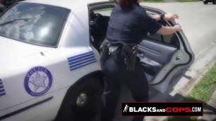Curvy blonde MILF officer is sitting on a black criminal's big cock in public.