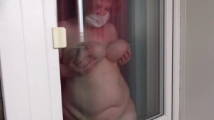 Lesbian peeps out the window for how fat milf with huge tits and with a big ass washes the window and undresses. Voyeur.